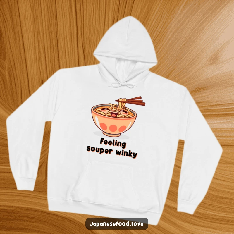 Funny hoodie showcasing a mischievous ramen bowl with chopsticks giving a delightful, playful wink.