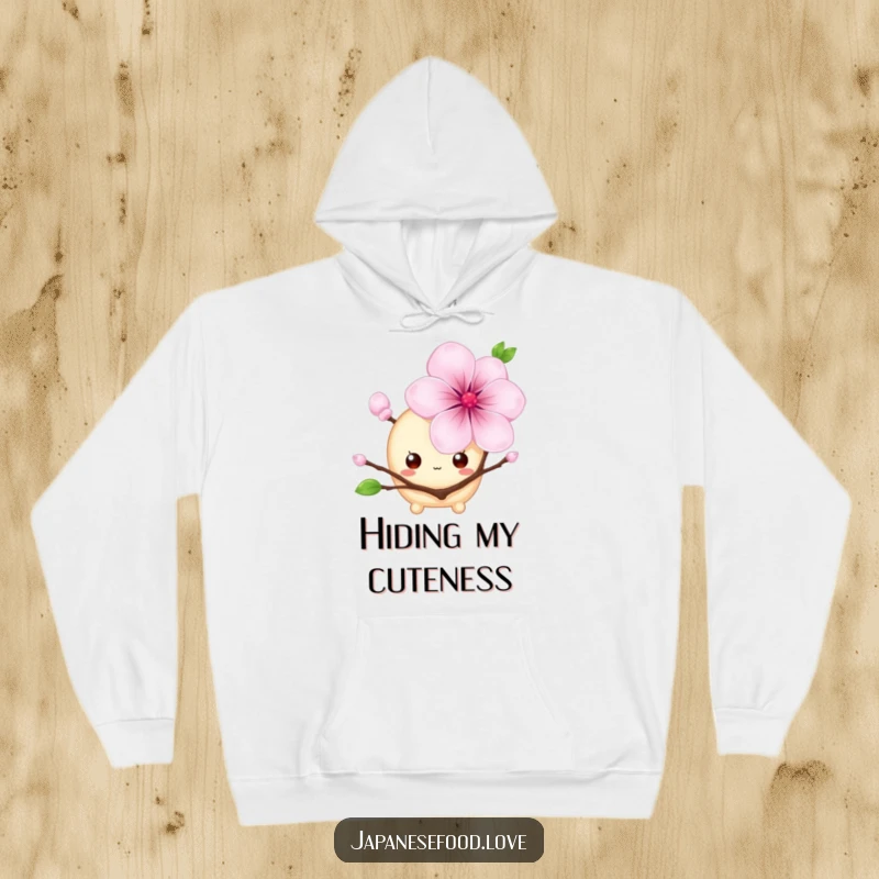 Funny hoodie featuring a shy mochi with big eyes hiding behind a cherry blossom, a charming and humorous kawaii design, great for a funny gift.