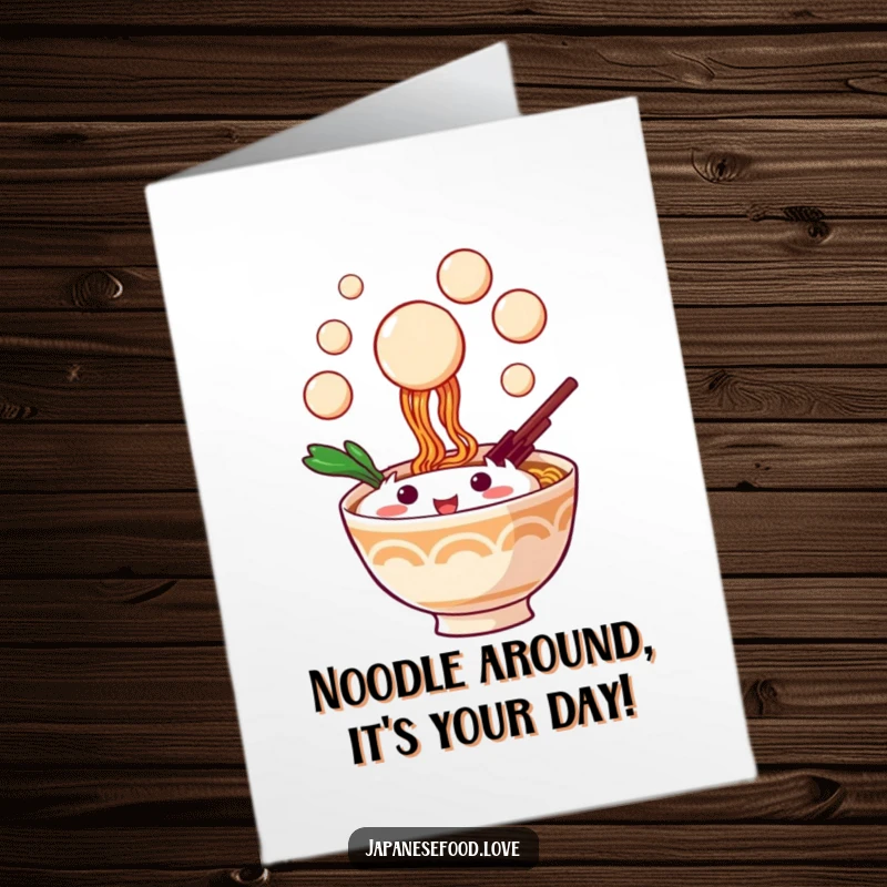 Funny Free Printable Birthday Card: Playful ramen bowl character joyfully trying to catch floating dango balls with a smile.